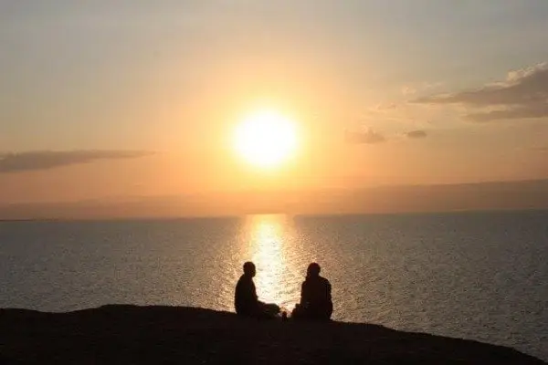 Giải Mã Giấc Mơ Thấy Đi Du Lịch Biển: Điềm Báo & Lời Khuyên An Tâm 3 Người ngắm hoàng hôn biển bình yên.